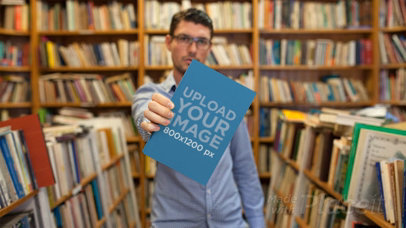 Stop Motion of a Young Man at a Library Holding a Book on His Hand Showing It