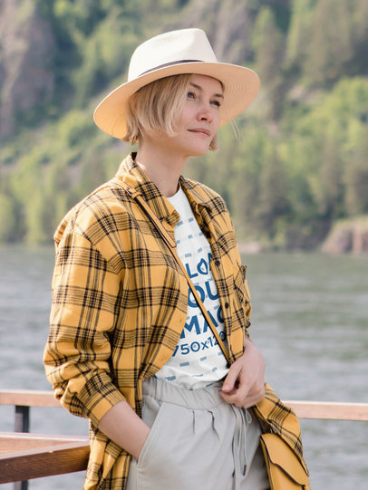 T-Shirt Mockup Featuring a Serious Woman Posing by a River 