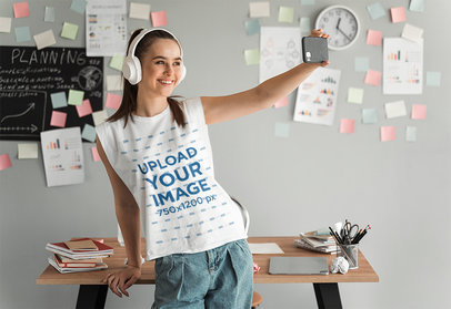 Sleeveless Tee Mockup Featuring a Happy Young Woman Taking a Selfie