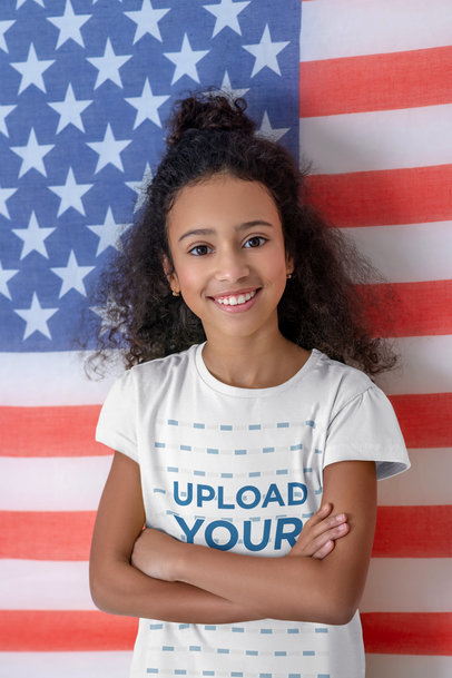 T-Shirt Mockup of a Smiling Girl Posing with an American Flag in the Background M17418-r-el2