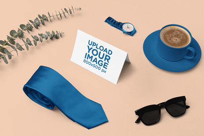 Mockup of a Horizontal Greeting Card Placed Next to a Tie m26989