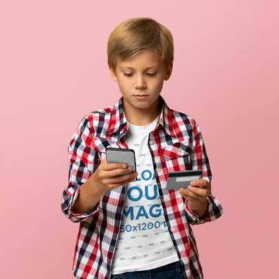 T-Shirt Mockup of a Kid Online Shopping with His Smartphone and a Credit Card m17974 r-el2