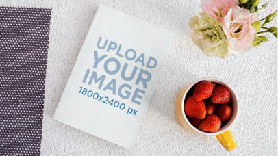 Book Lying on a Friendly Desk While Strawberries Disappear From a Cup in Stop Motion a13872
