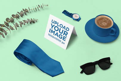 Mockup of a Greeting Card Surrounded by Apparel Accessories and Coffee m26995
