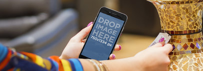 iPhone 6 in Portrait Position Mockup Featuring a Woman Shopping for Decorations
