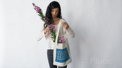 Pretty Woman Putting Flowers in her Tote Bag Against a White Background in Stop Motion