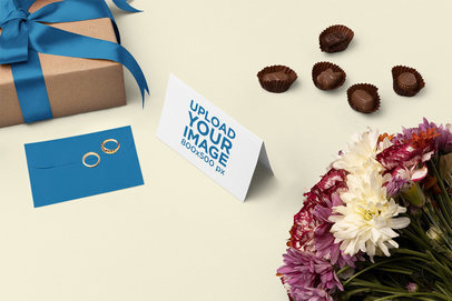 Mockup of a Greeting Card Placed Next to Some Flowers and Presents m26990