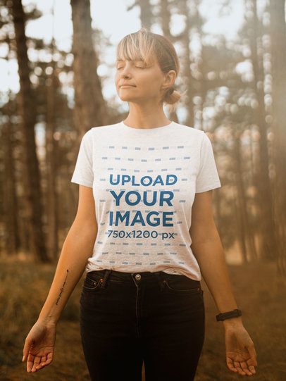 T-Shirt Mockup Featuring a Woman Meditating at the Forest