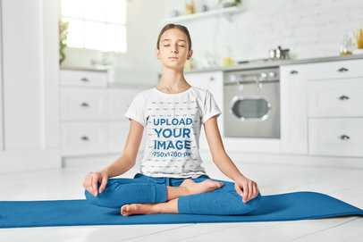 T-Shirt Mockup Featuring a Girl Practicing Yoga in The Kitchen