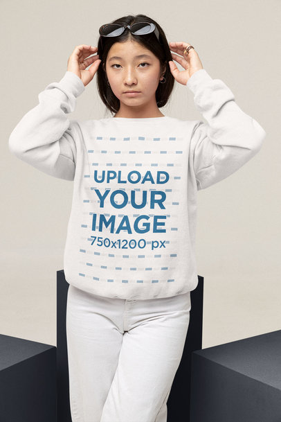 Mockup of a Teenager Wearing a Sweatshirt and Sunglasses at a Studio