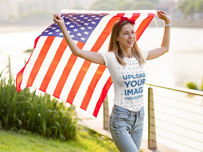 T-Shirt Mockup Featuring a Happy Woman Walking With the American Flag