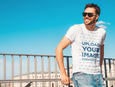 Round-Neck Tee Mockup of a Man with Sunglasses Leaning on a Railing