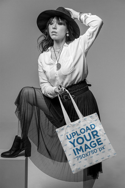 Sublimated Tote Bag Mockup Featuring a Stylish Woman at a Studio