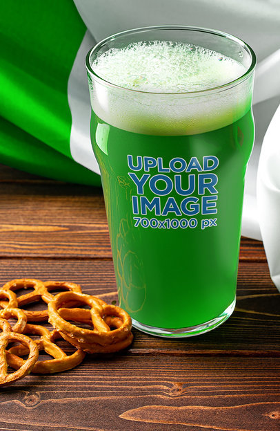 Mockup of a Beer Glass Placed Next to Pretzel-Shaped Snacks