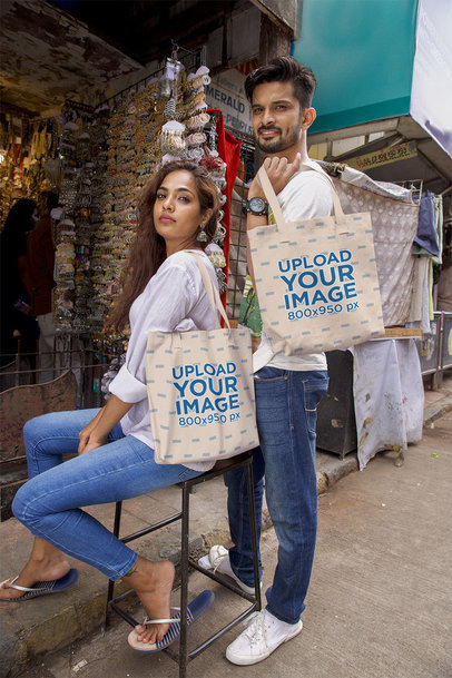 Tote Bag Mockup Featuring a Couple Posing Together