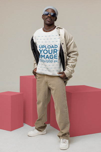 Mockup of a Stylish Man Wearing a Sweatshirt and a Beige Outfit at a Studio