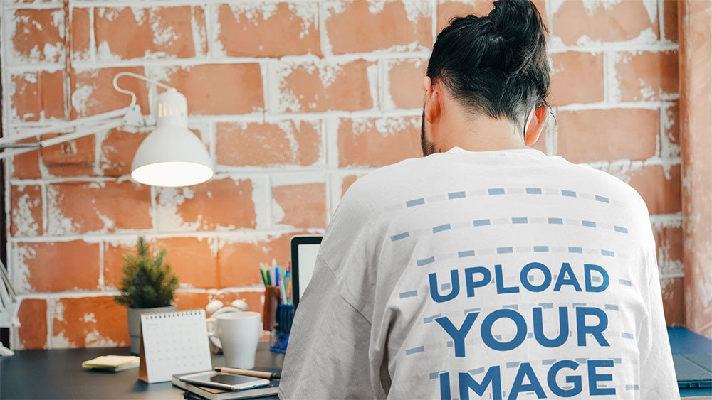Back View Mockup of a Man Wearing an Oversized T-Shirt While Working from Home