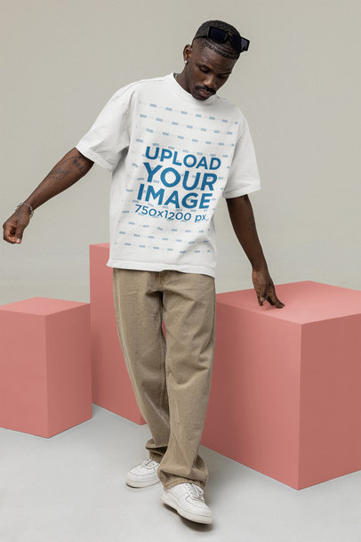 Mockup of a Man Wearing a T-Shirt and Sunglasses at a Studio