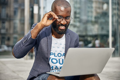 Heathered Tee Mockup of a Bearded Man in a Blazer Using a Laptop on His Lap m11671-r-el2