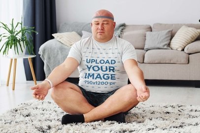 Mockup Featuring a Man Meditating in a Plus Size Heathered Tee at Home m24293-r-el2