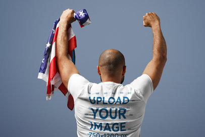 Back-View T-Shirt Mockup of a Man Holding an American Flag