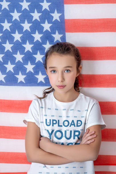 T-Shirt Mockup Featuring a Blue-Eyed Girl Posing Against an American Flag m17417-r-el2