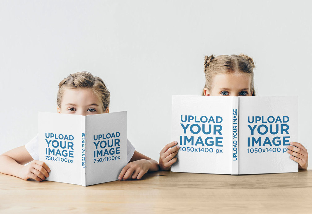 Mockup of Two Girls Holding Books Close To Their Faces