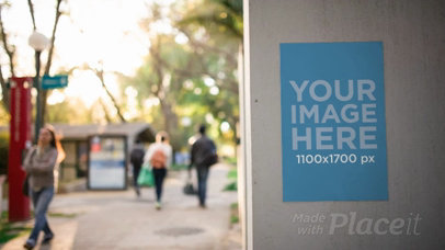 Flyer Video Glued to a Concrete Wall While People are Passing By