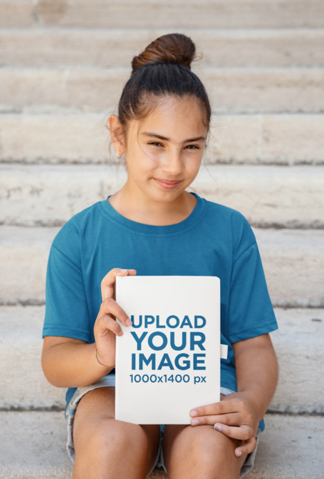 Mockup of a Brunette Girl Holding a Book With Her Hands