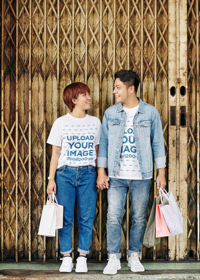 Round-Neck T-Shirt Mockup Featuring a Happy Couple Holdings Hands and Shopping Bags