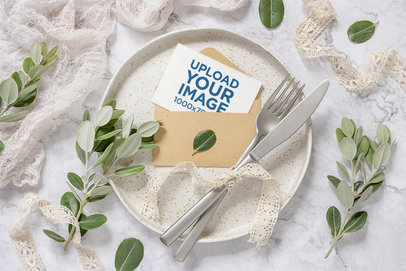 Mockup of a Wedding Program in an Envelope Featuring Plant Ornaments