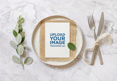 Mockup of a Wedding Program Placed Over a Plate Featuring a Marble Table