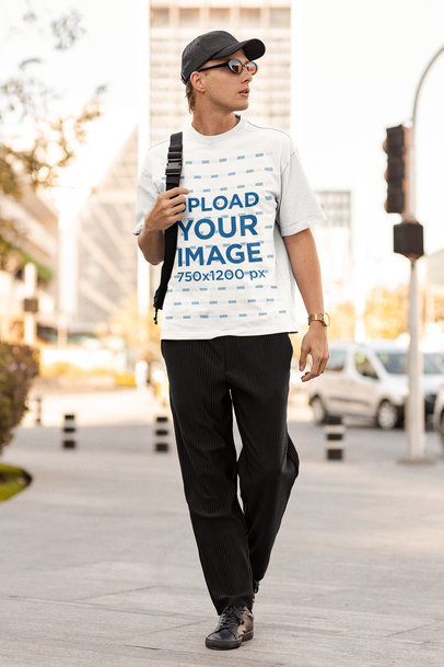 Mockup of a Tall Man With a Round-Neck Tee Walking on The Sidewalk