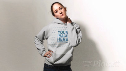 Blonde Girl Wearing A Pullover Hoodie in Stop Motion Against a White Background a13304