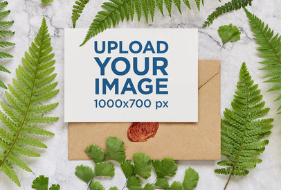 Wedding Program Mockup Featuring an Envelope and Fern Leaves