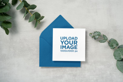 Wedding Program Mockup Featuring an Envelope and Some Plants