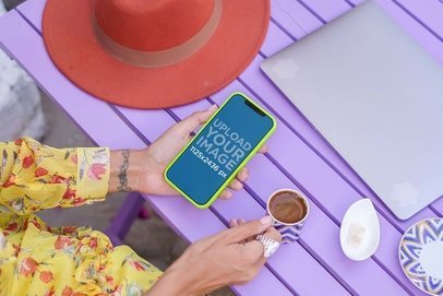 Mockup of a Woman Checking Her iPhone 12 Pro by a Purple Table