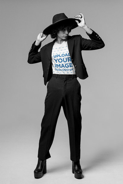 Tee Mockup Featuring a Man Touching His Hat at a Studio