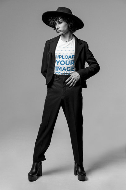 T-Shirt Mockup of a Man Posing at a Studio with a Black Outfit