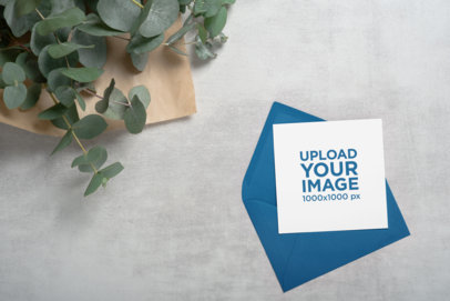 Square Wedding Program Mockup Featuring an Envelope and Some Plants