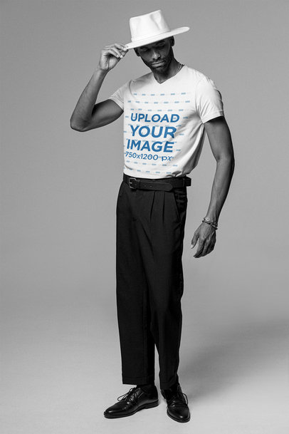 T-Shirt Mockup of a Tall Fashionable Man at a Studio