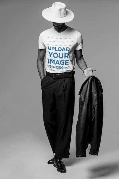 V-Neck Tee Mockup of a Man Holding a Leather Jacket at a Studio
