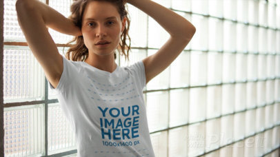 Blonde Young Woman Posing Against a Window Wearing a T-Shirt in Stop Motion
