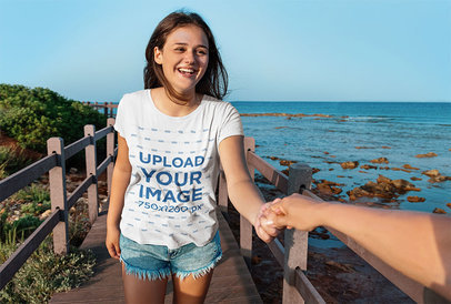 T-Shirt Mockup of a Happy Teenage Girl Walking by the Ocean