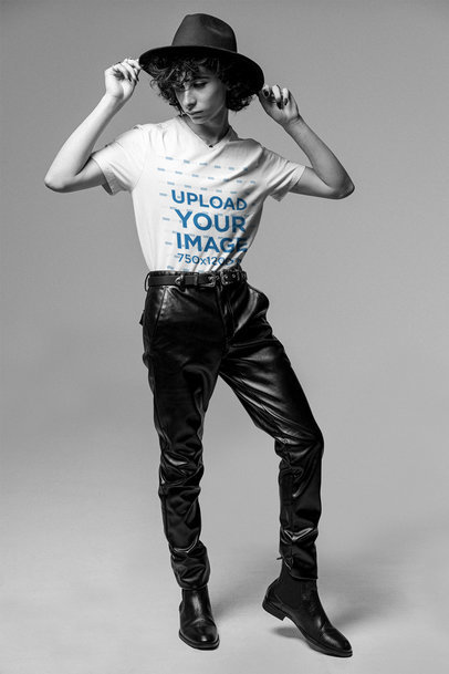 Mockup of a Man Touching His Hat and Wearing a V-Neck Tee at a Studio