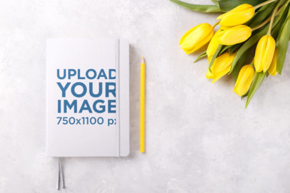 Mockup of a Wedding Notebook Featuring Yellow Tulips