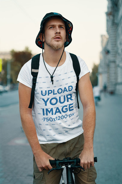 T-Shirt Mockup Featuring a Serious Bearded Man Riding a Bike