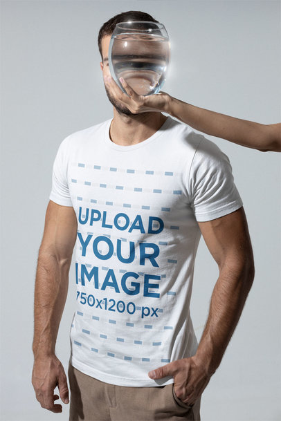 T-Shirt Mockup of a Man Looking Through a Glass Vase with Water m28422