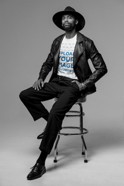 T-Shirt Mockup of a Tall Man Sitting on a Stool