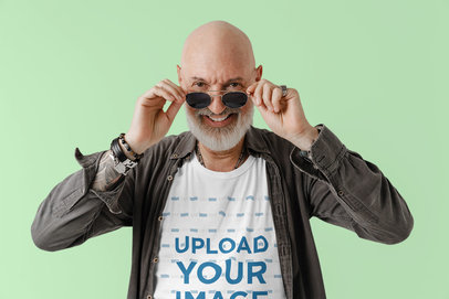 T-Shirt Mockup Featuring a Smiling Bald Man Taking Off His Sunglasses m27211 r-el2
